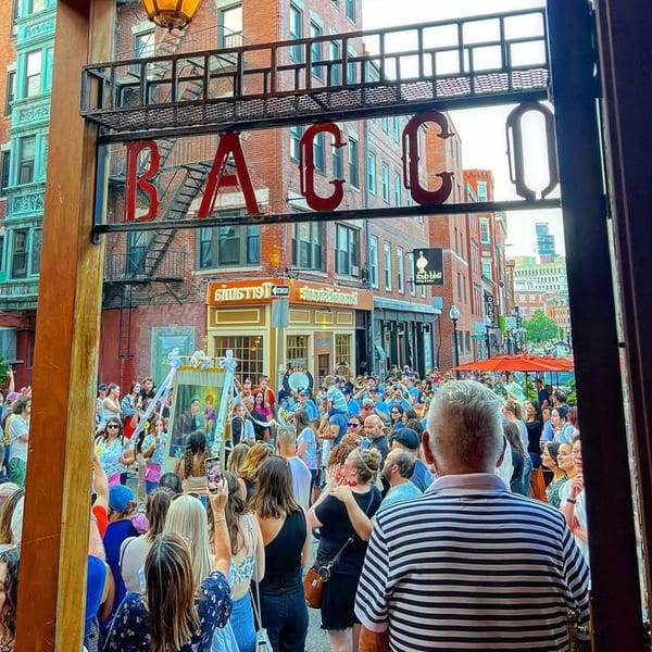 View from Bacco Ristorante & Bar of a lively street festival with a large crowd.
