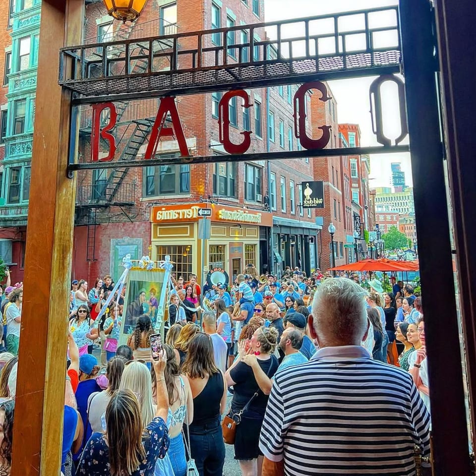 View from Bacco Ristorante & Bar of a lively street festival with a large crowd.